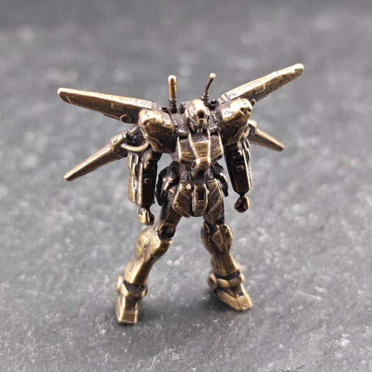 Brass Winged Mobile Suit Micro Figurine — Sci-Fi Mecha Diorama and Terrarium Sculpture