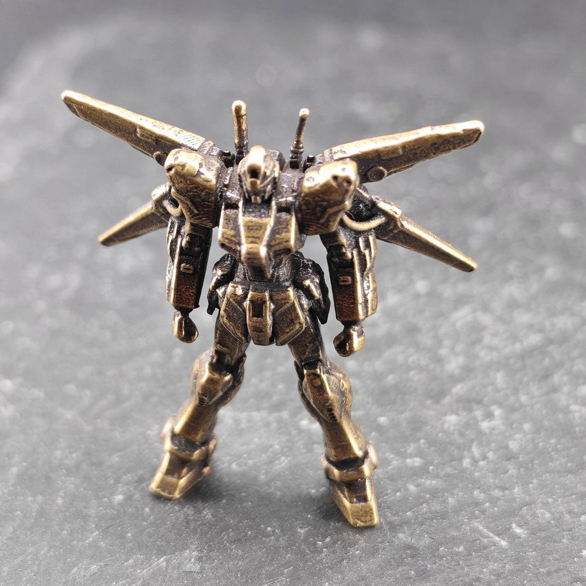 Brass Winged Mobile Suit Micro Figurine — Sci-Fi Mecha Diorama and Terrarium Sculpture