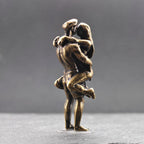 Lifted Off the Ground — Brass Kissing Couple Figurine