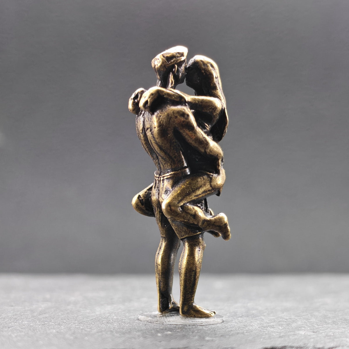 Lifted Off the Ground — Brass Kissing Couple Figurine