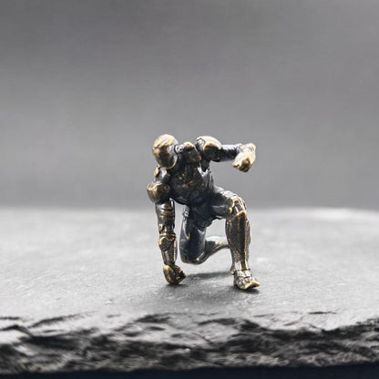Brass Kneeling Armoured Hero Figurine — Red & Gold Exosuit Desk Collectible
