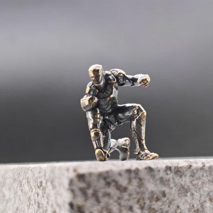 Brass Kneeling Armoured Hero Figurine — Red & Gold Exosuit Desk Collectible
