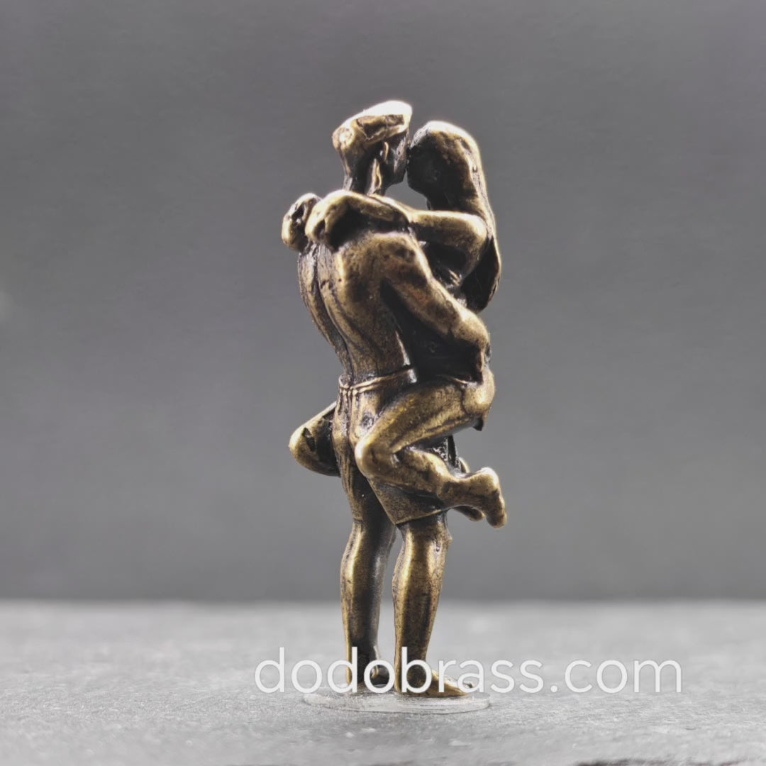 Lifted Off the Ground — Brass Kissing Couple Figurine